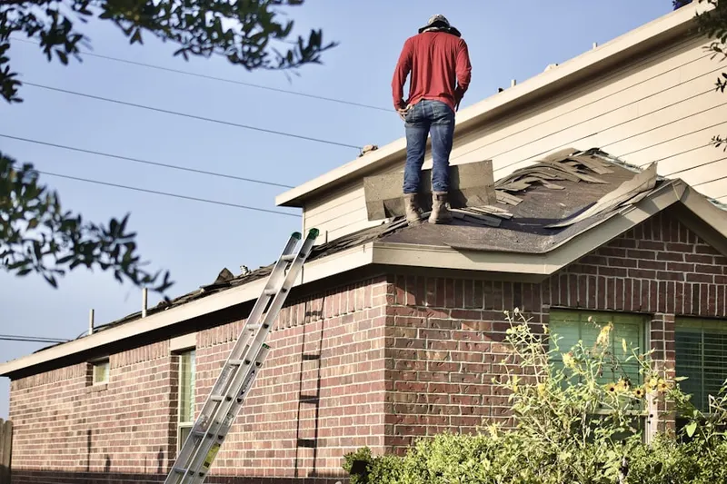 Professional roofer working on a residential roof in Keene